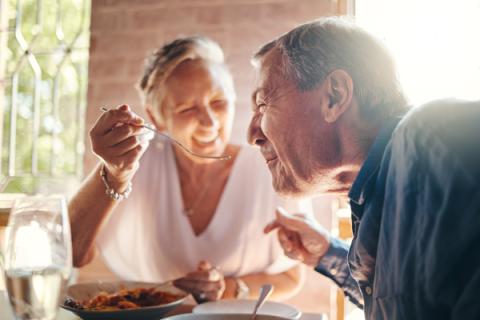 Elderly couple enjoying a meal.