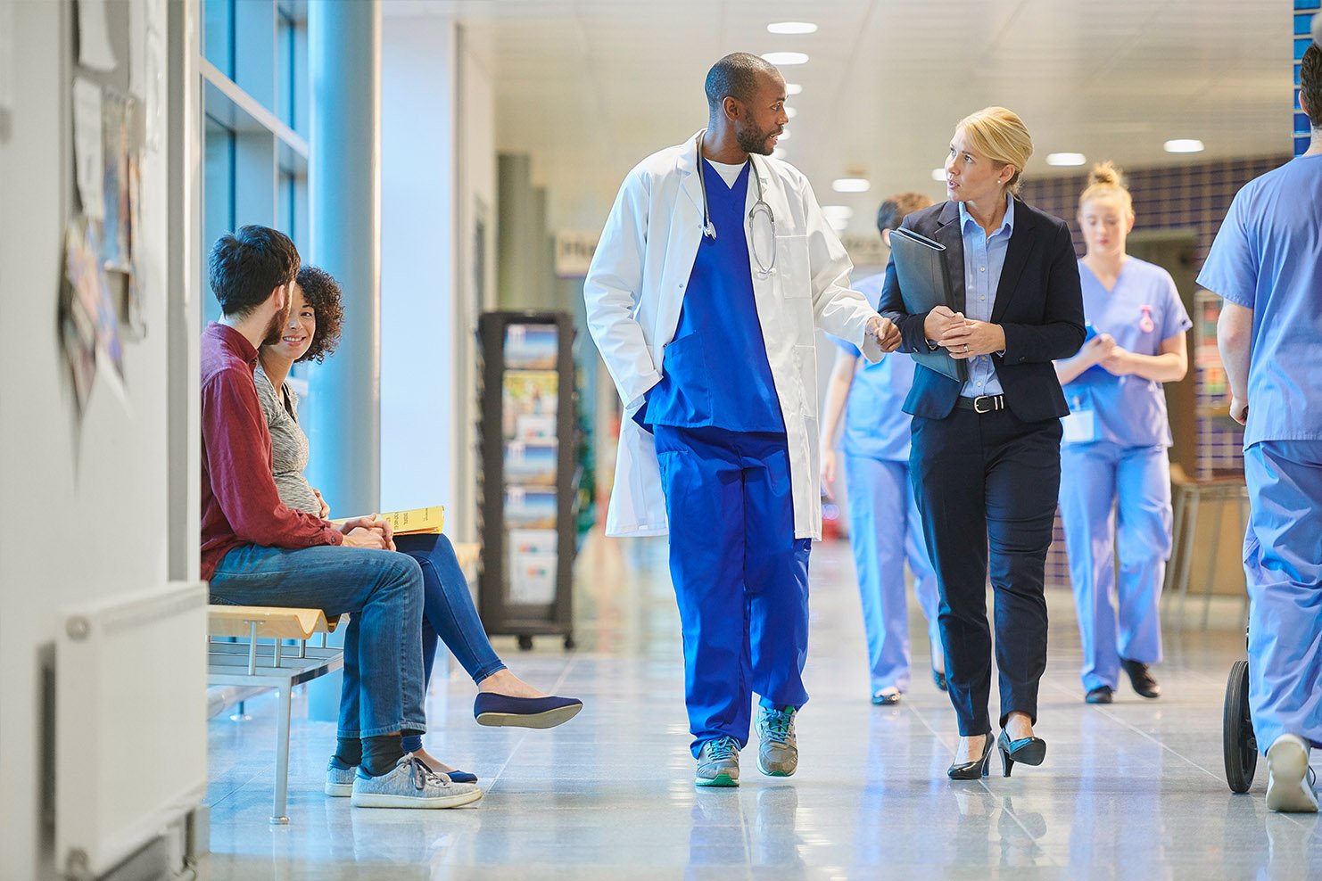 Doctor and staff walking in hall