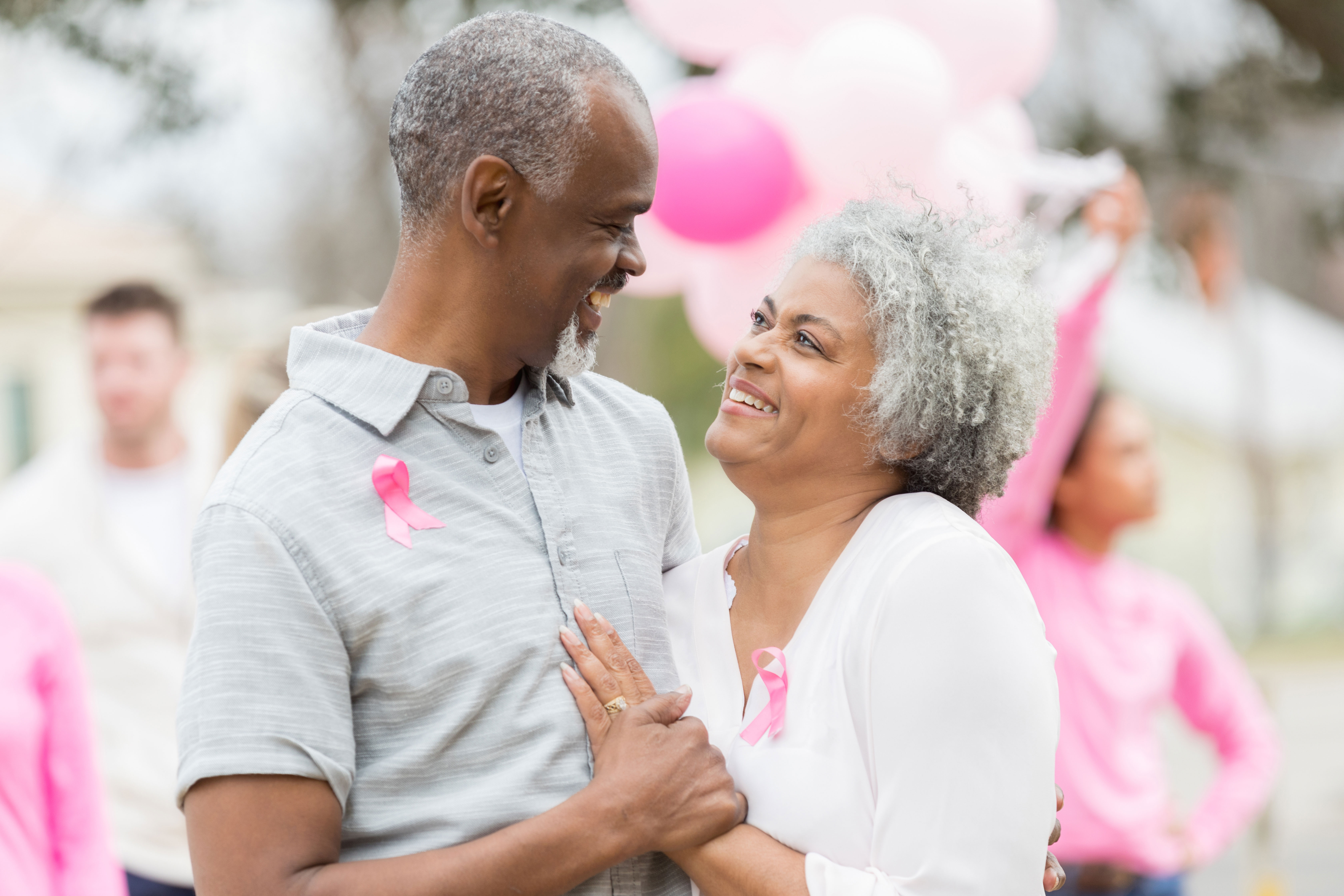 Happy couple at a breast cancer awareness event