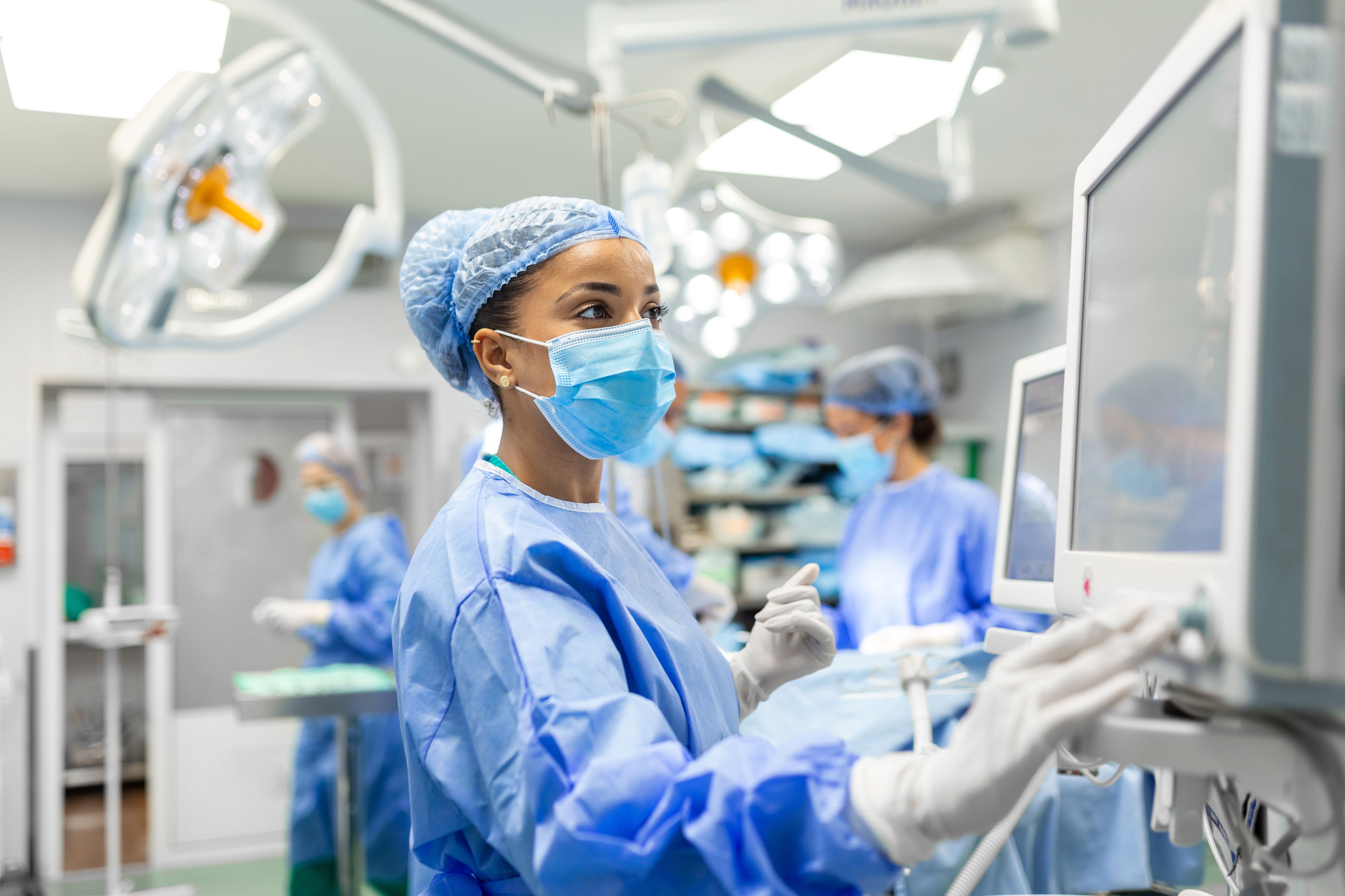 A medical resident checking a monitor