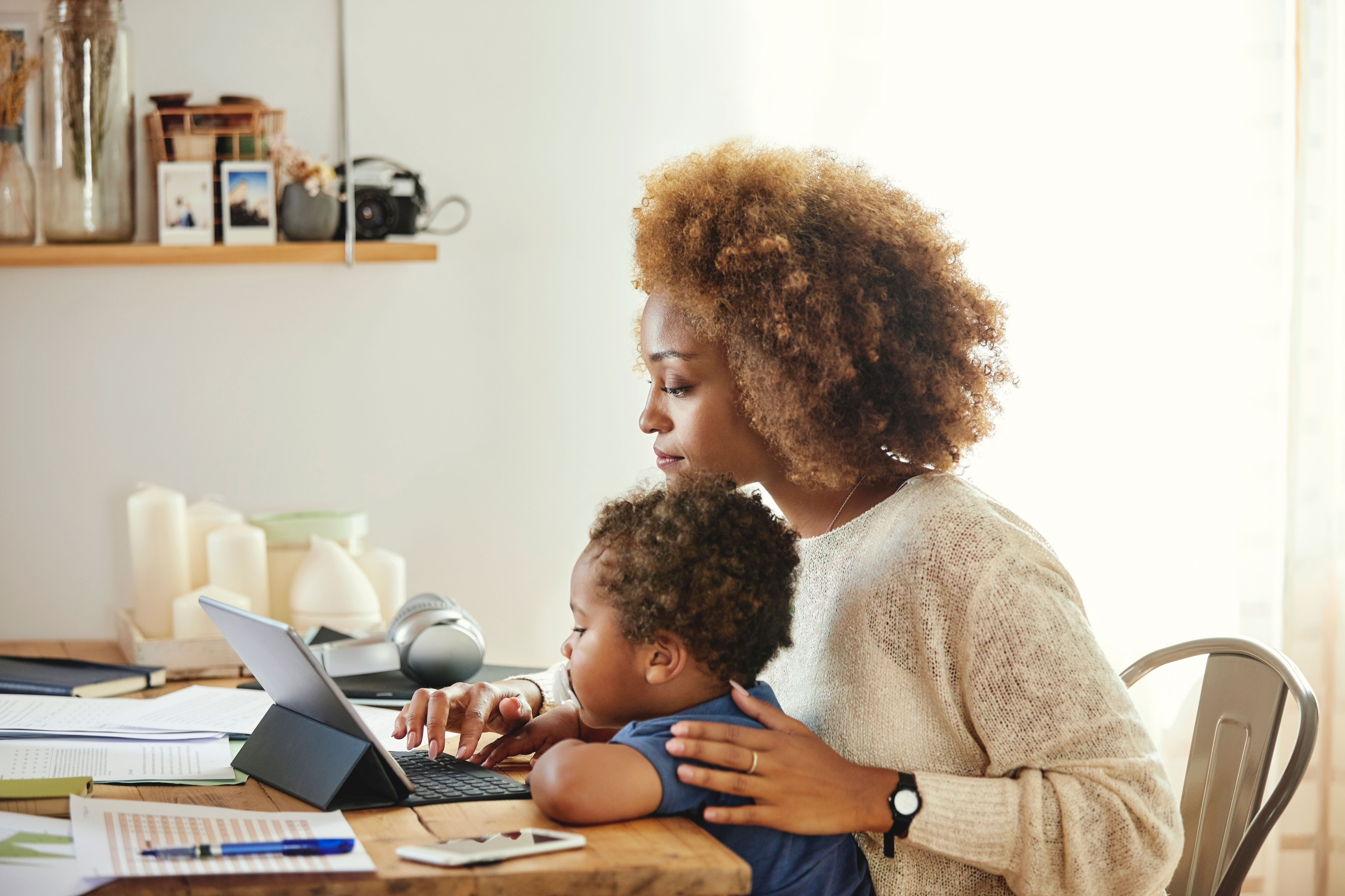 Mother and young son sitting together at a laptop