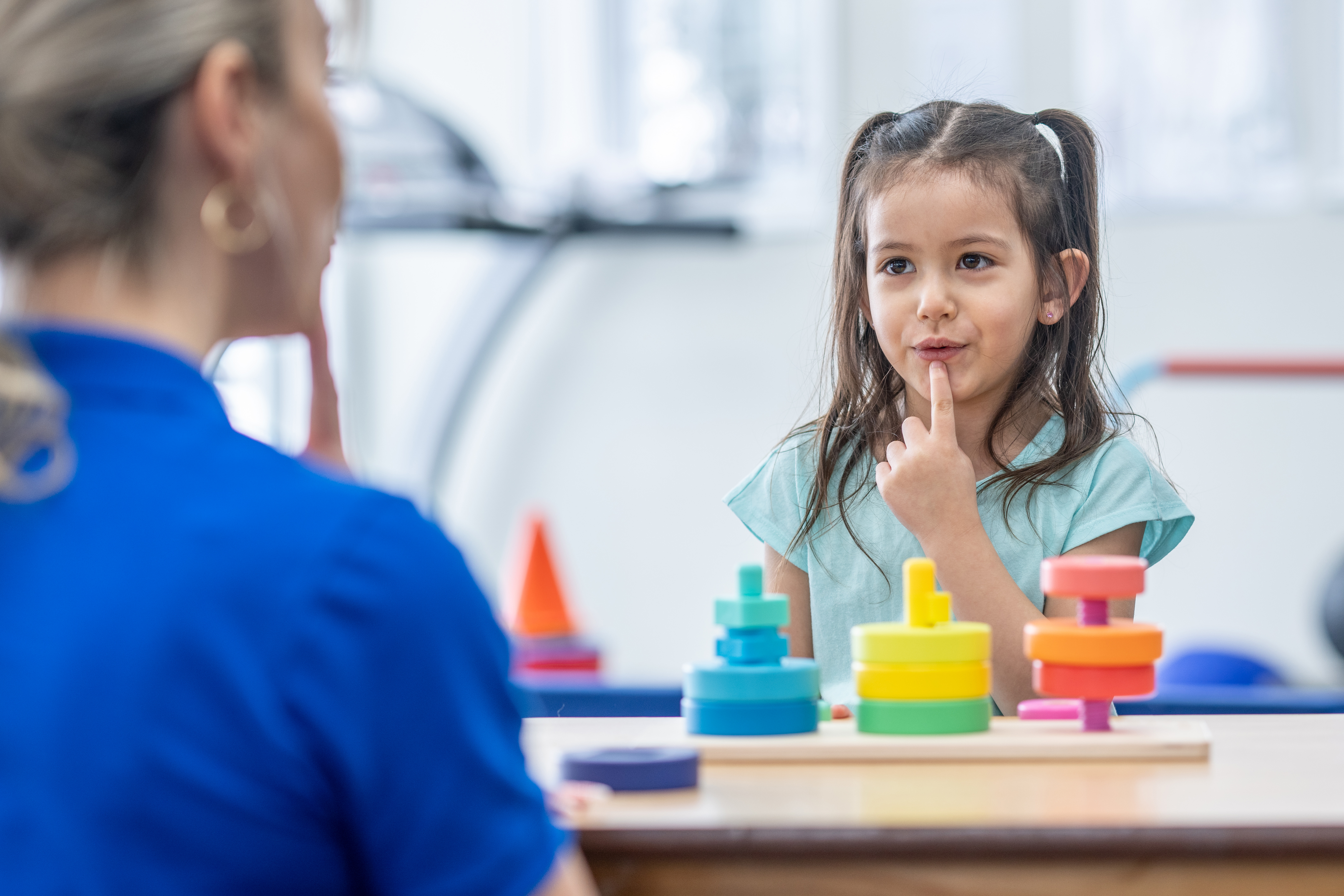 Young girl working with a speech therapist
