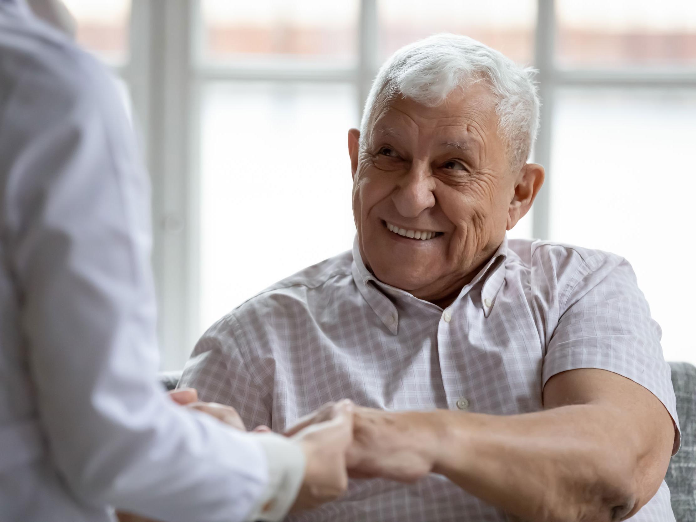 A mature man expresses gratitude towards his physician