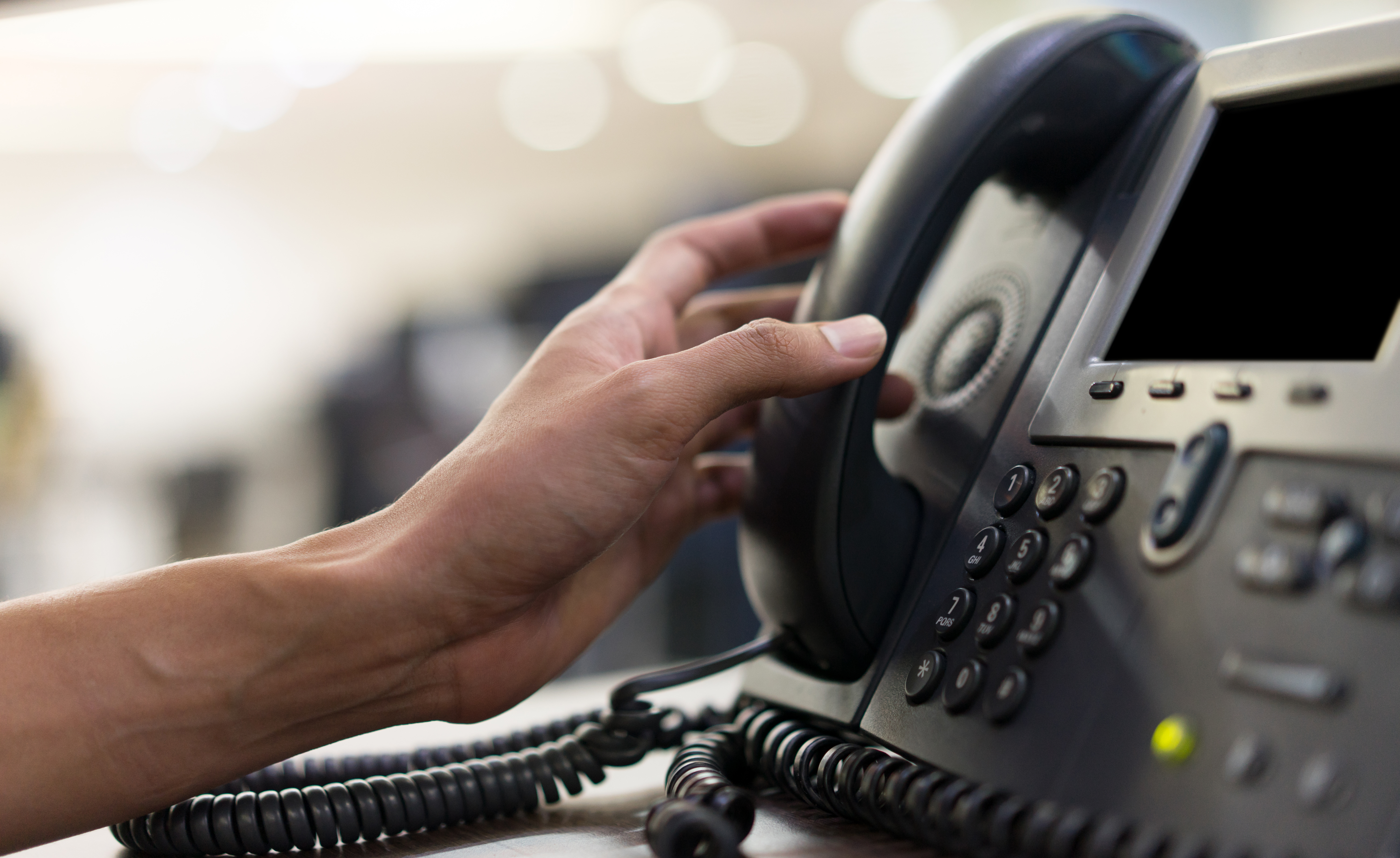 Hand picking up phone