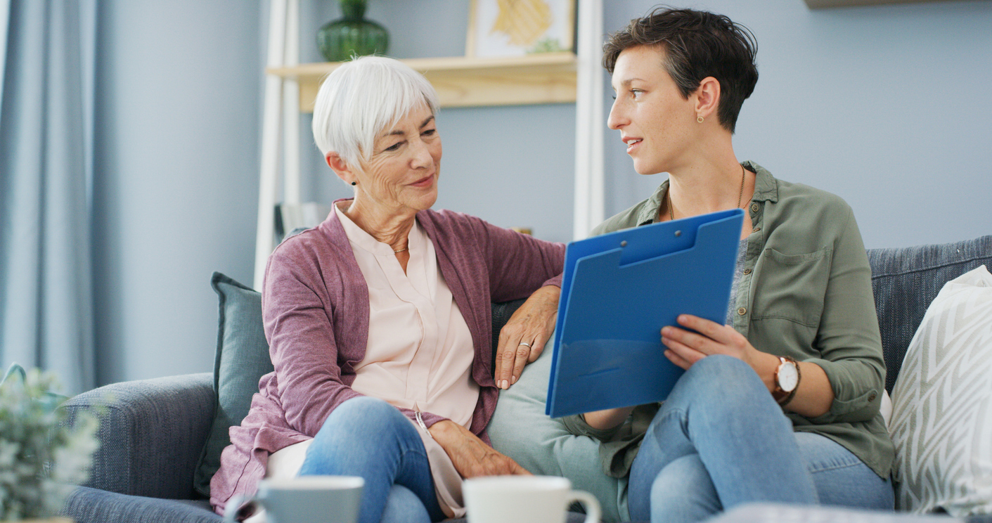 senior woman and daughter with document