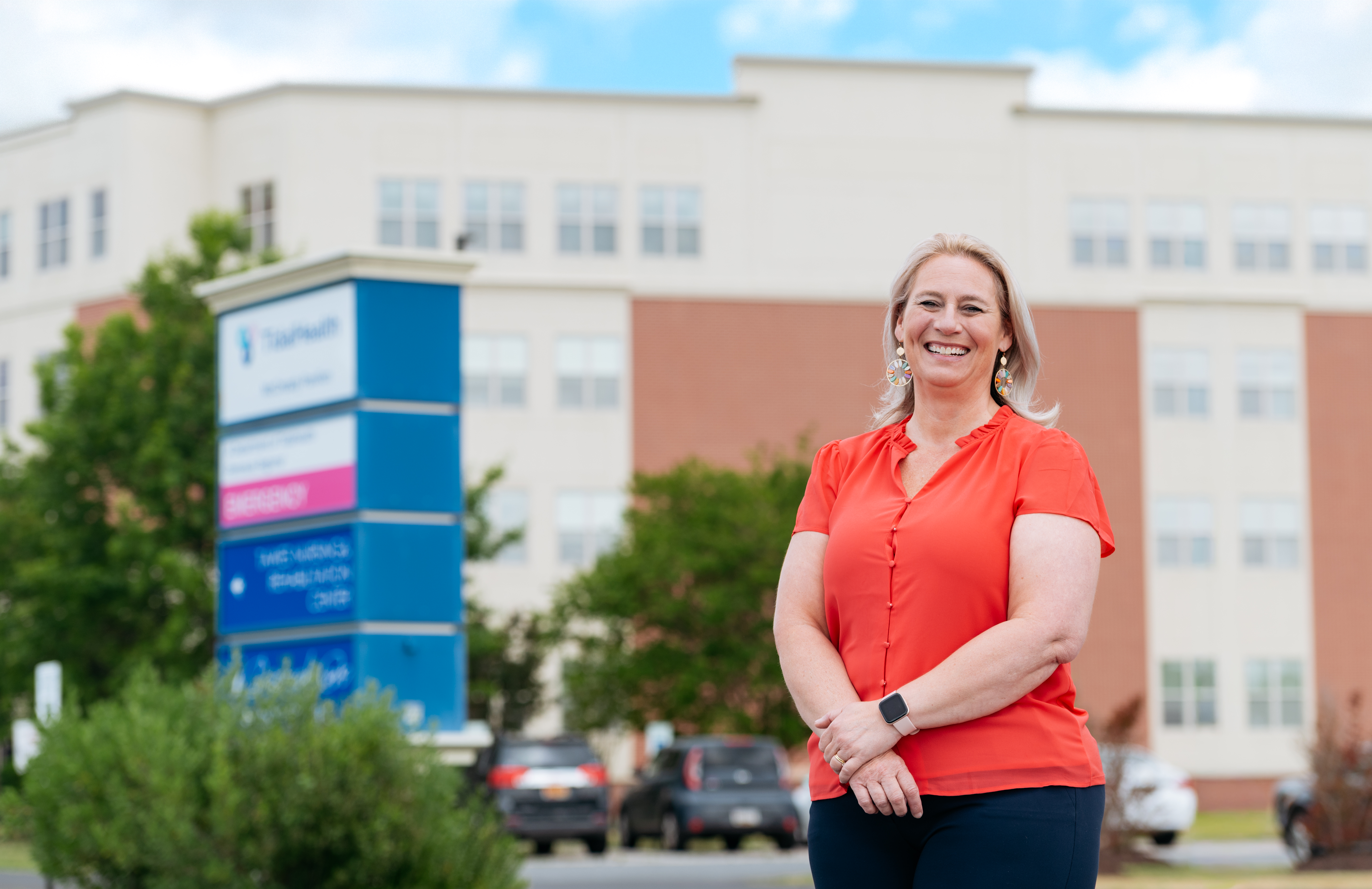 a woman standing in front of a nursing home