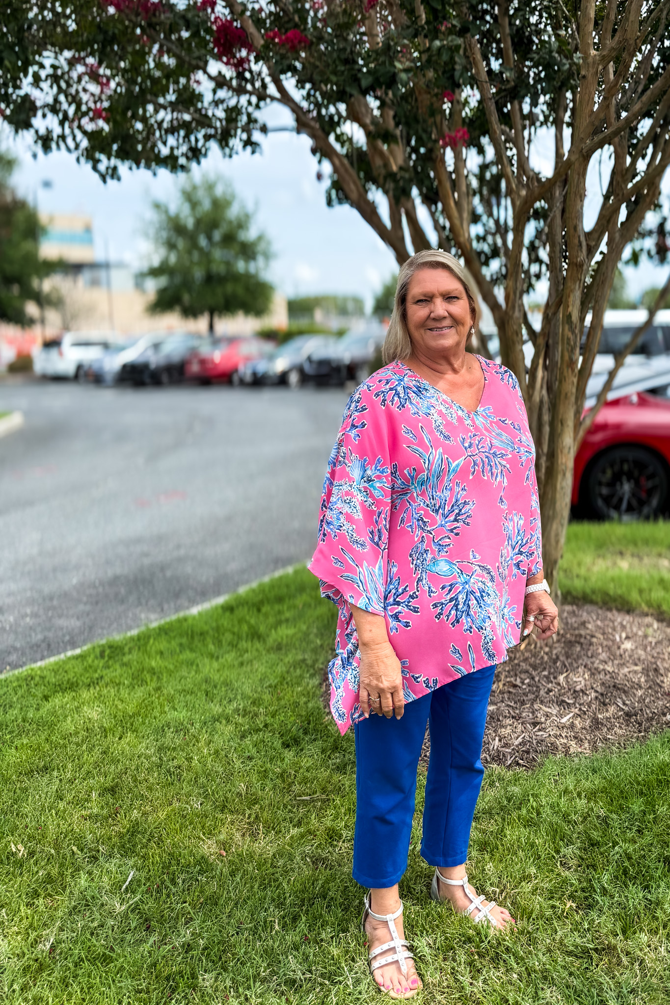 woman by a tree in a parking lot