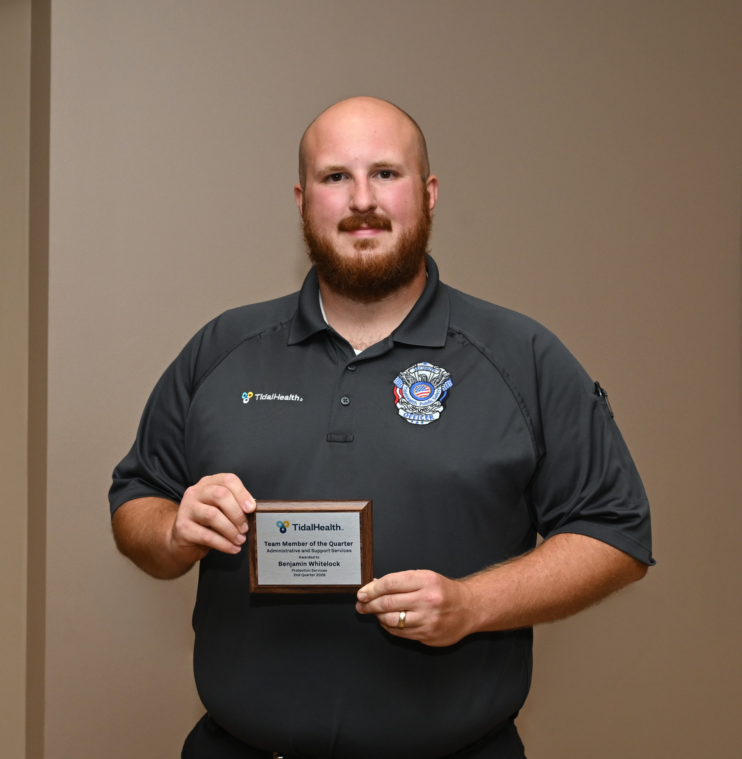 security guard holding an award