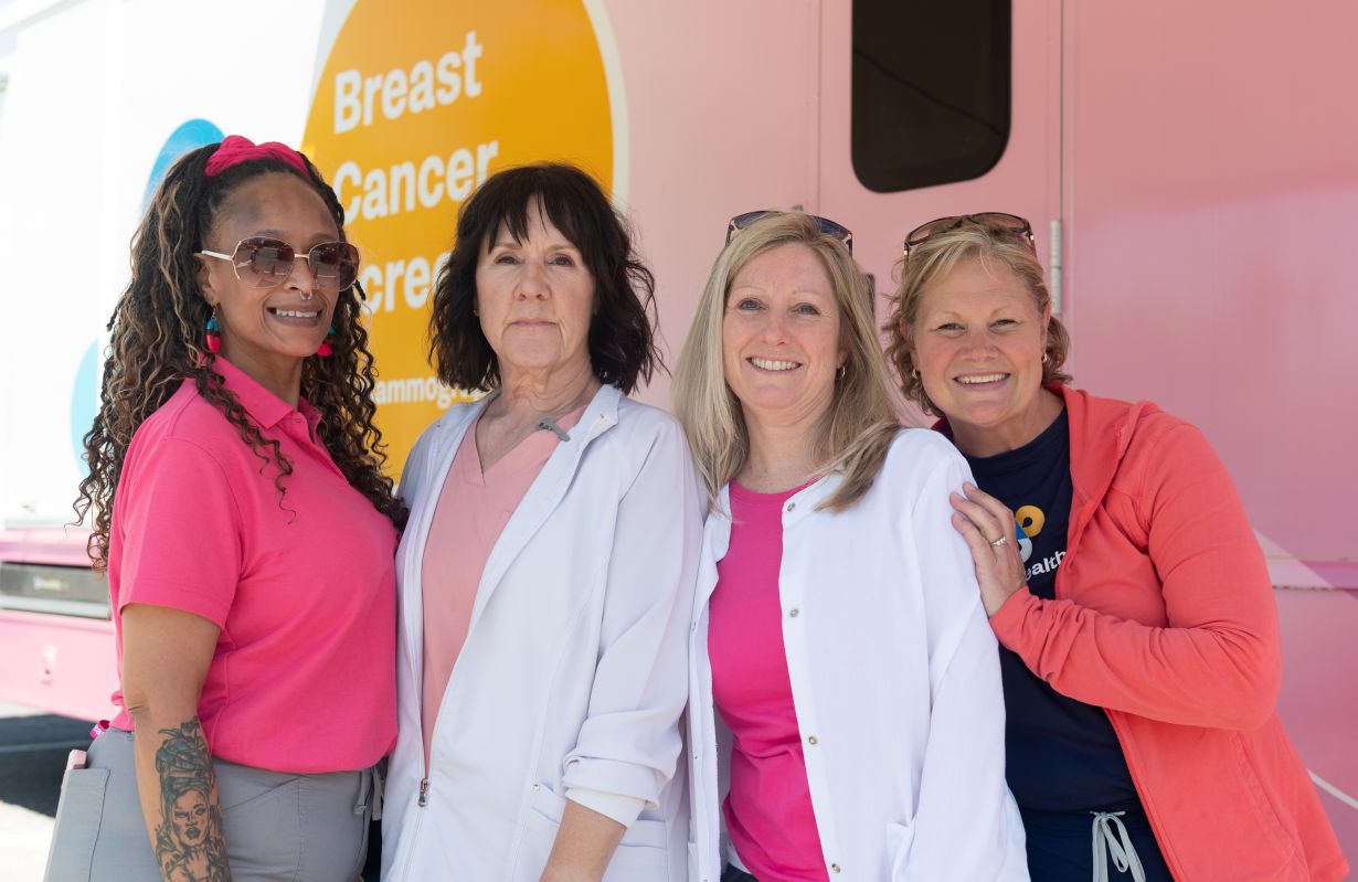 women in pink standing near eachother