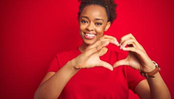 woman making a heart shape with her hands