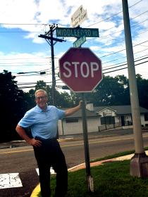 Dr. Stephen Carey with sign at Memorial Drive in Seaford, Del.