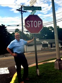 Dr. Stephen Carey with sign at Memorial Drive in Seaford, Del.