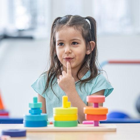 A young girl works with a therapist
