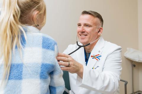 Dr. Jason Coleman examines a pediatric patient