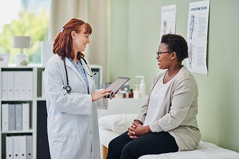 A healthcare worker meets with a patient