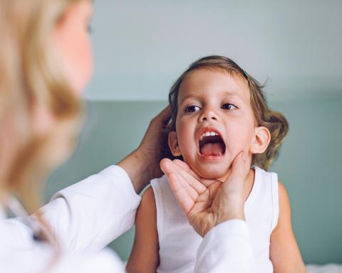Child at a Medical Checkup: ENT Examining a Little Girl's Throat