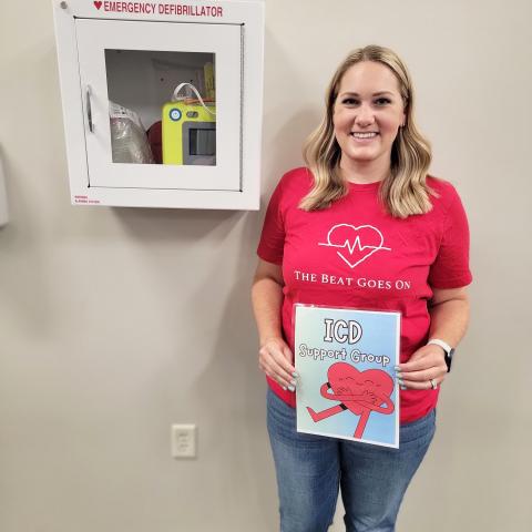 Jamie Ensor next to an AED