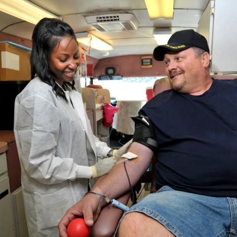 Man donating blood on a blood mobile