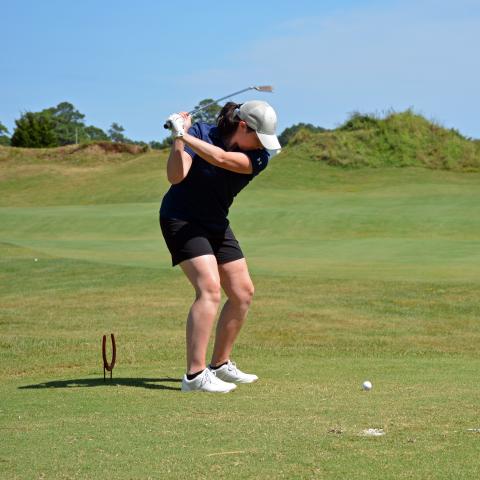 woman putting on green