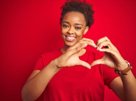 woman making a heart shape with her hands