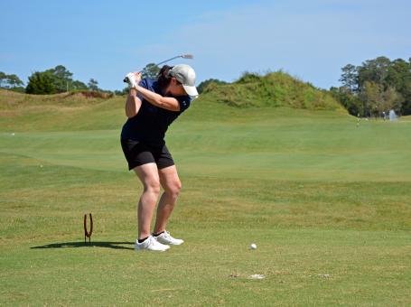 woman putting on green
