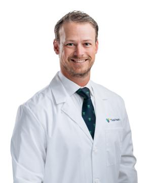 a doctor wearing a tie and white coat