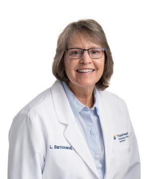 a woman with glasses in a white coat