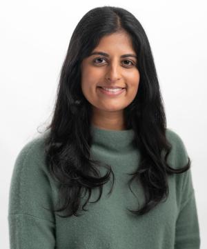 a woman in a green sweater posing for her portrait