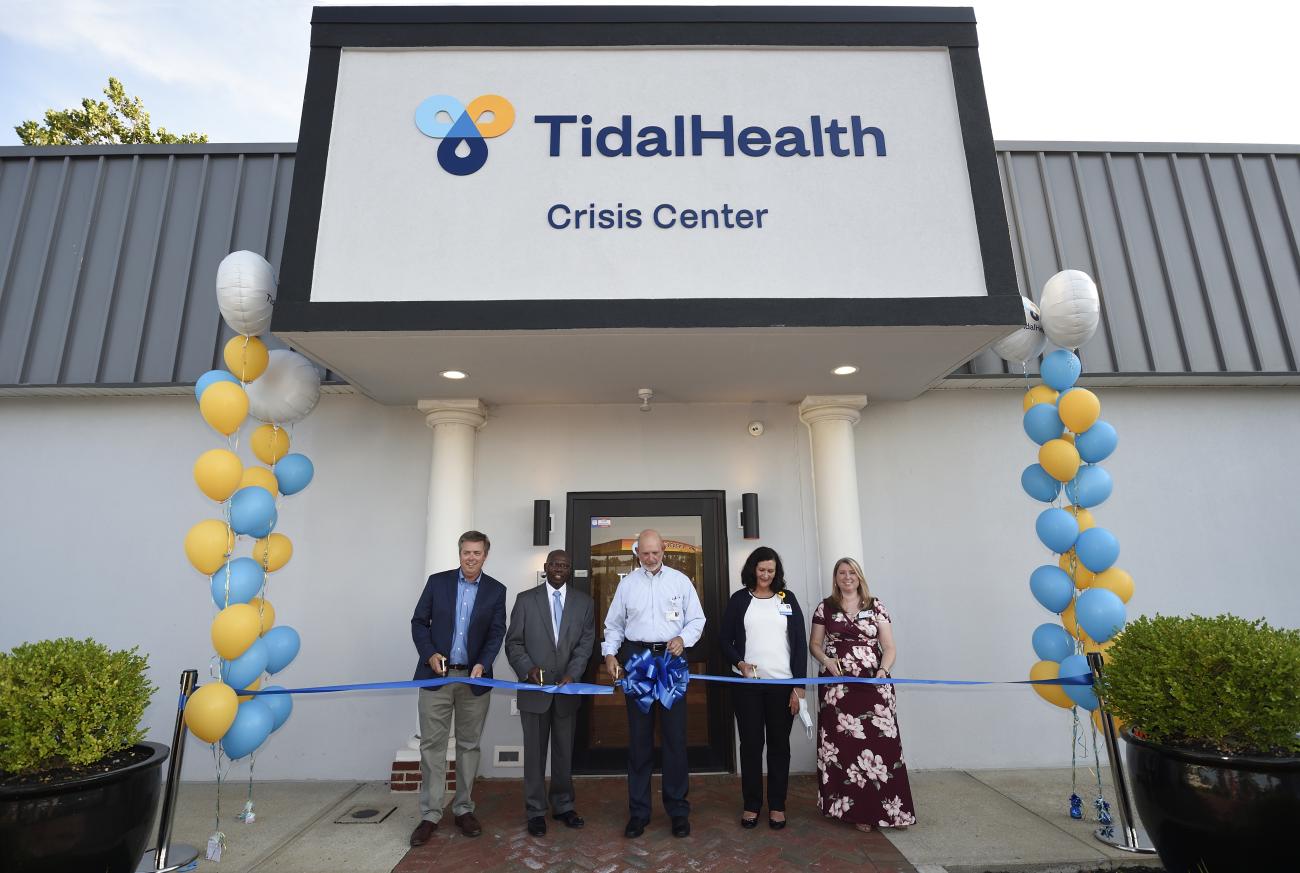 Cutting the ribbon August 4 to officially open the TidalHealth Crisis Center are, from the left, Steve Leonard, President/CEO of TidalHealth; Julius Zant, MD, Chairperson of the TidalHealth Peninsula Regional Board of Directors; Tim Feist, Vice President of Ambulatory Services/Corporate Compliance Officer; Ingrid Orinda, MD, Psychiatrist, TidalHealth Crisis Center and Stacey Walker, Clinical Manager of TidalHealth Behavioral Health Crisis Services.