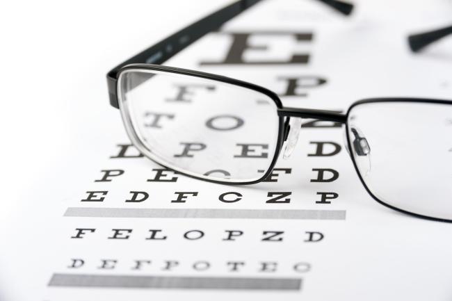 Eye glasses on top of a vision chart