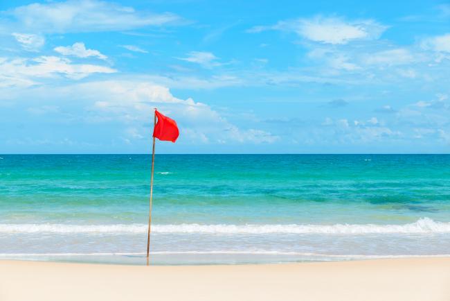 Rip current warning flag on the beach