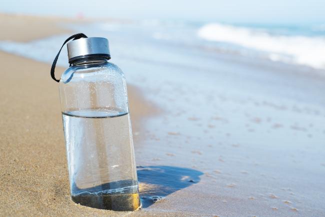 water bottle in the sand on the beach