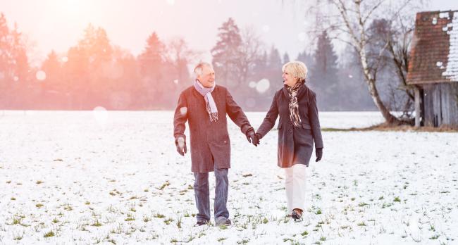 Senior couple walking in the snow