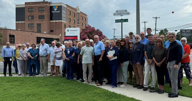 Dr. Stephen Carey with sign at Memorial Drive in Seaford, Del.