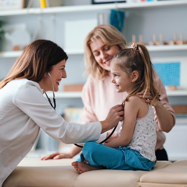 Doctor with child patient and mother