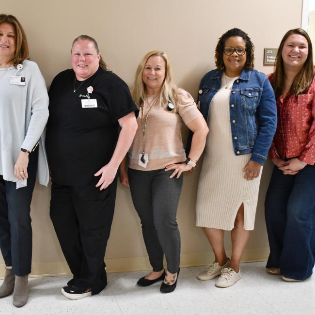 Five women gather for a group photo after two were honored with Guardian Angel pins.