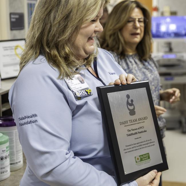 woman holding an award