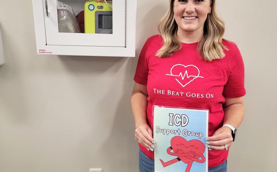Jamie Ensor next to an AED