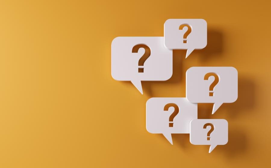 White question mark bubbles on a yellow background