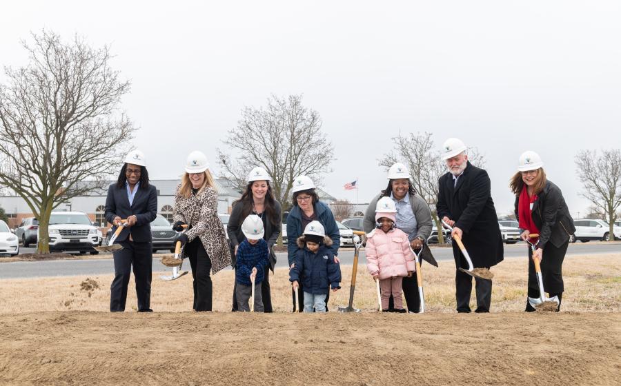 A group of adults and three young kids break ground for TidalHealth Kids in Seaford.