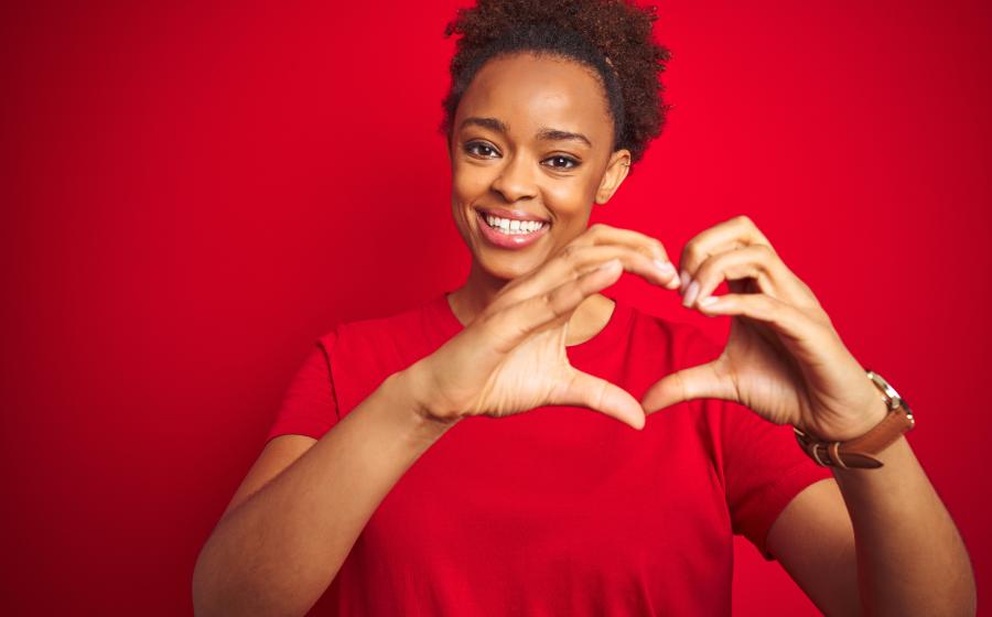 woman making a heart shape with her hands