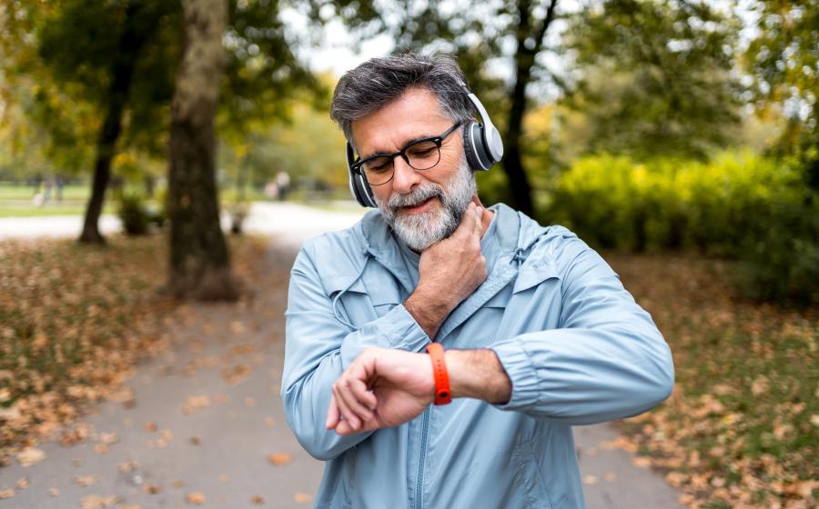 man exercising checking blood pressure