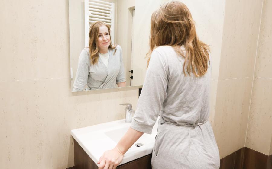 Woman looking in mirror