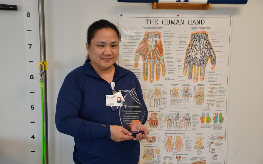 Genevieve Luzano poses with her Marc McDonald Award