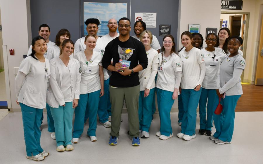 Chad Sutton is surrounded by Radiologic Technology students as he accepts an award.