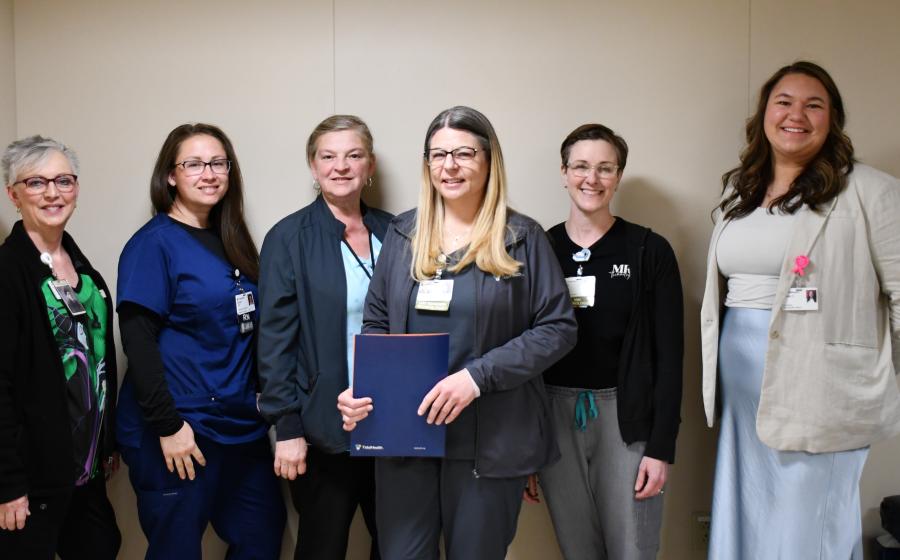 Group photo featuring Alexis Irwin with her Guardian Angel award letter