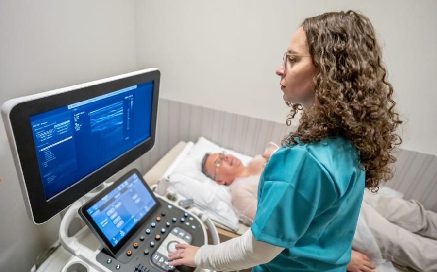Ultrasound tech preforming on male patient