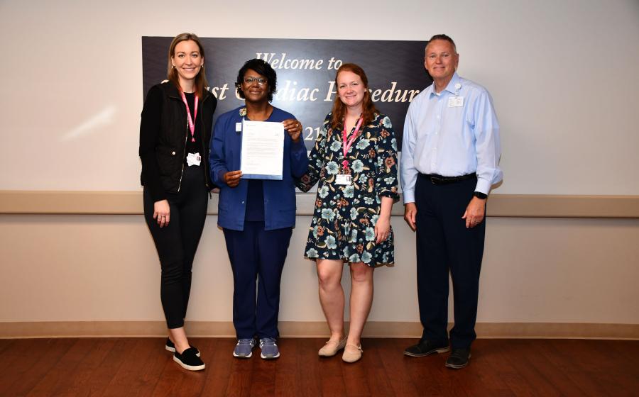 From left, Hillary Mozeik, executive assistant and donor relations coordinator for the TidalHealth Foundation; Guardian Angel recipient Cassandra Todd, RN; Jenna MacDougall, operations manager for the TidalHealth Foundation; and Scott Phillips, vice president of supply chain and support services, pose for a photo after Todd was presented with her Guardian Angel pin. 