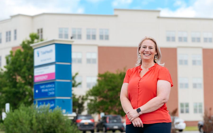 a woman standing in front of a nursing home
