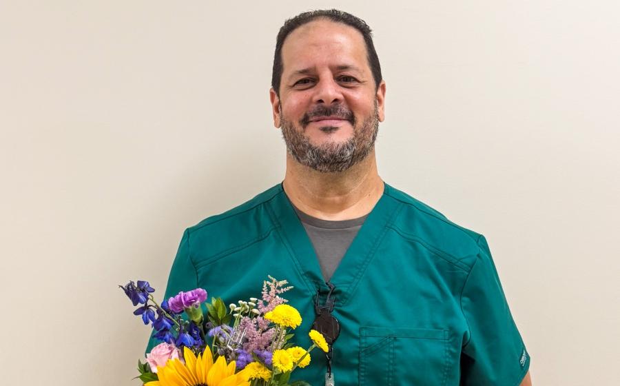 cropped photo of a man holding flowers